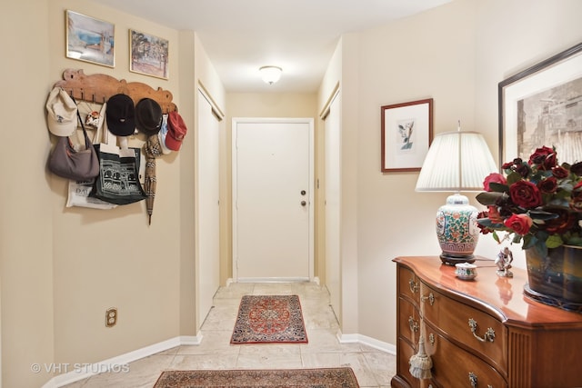 entryway with light tile patterned floors