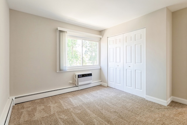 unfurnished bedroom with carpet, a closet, baseboard heating, and a wall mounted air conditioner