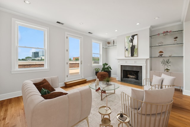 living room with light hardwood / wood-style flooring and ornamental molding