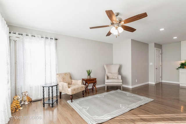 sitting room featuring hardwood / wood-style floors, a healthy amount of sunlight, and ceiling fan