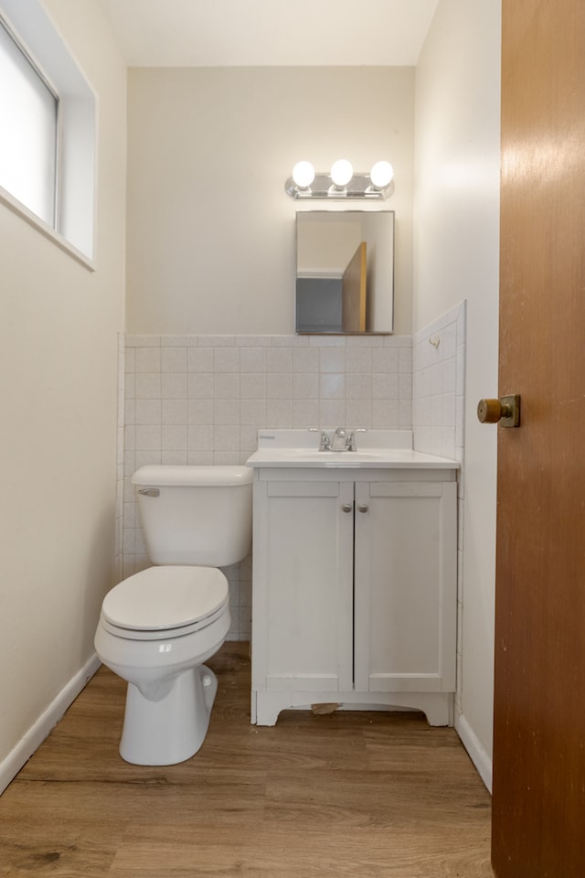 bathroom with vanity, toilet, and hardwood / wood-style flooring