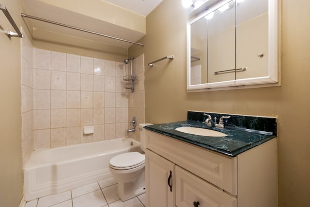 full bathroom with tile patterned floors, tiled shower / bath combo, vanity, and toilet