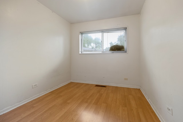 empty room with light hardwood / wood-style flooring