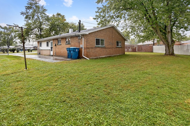 rear view of house featuring a lawn