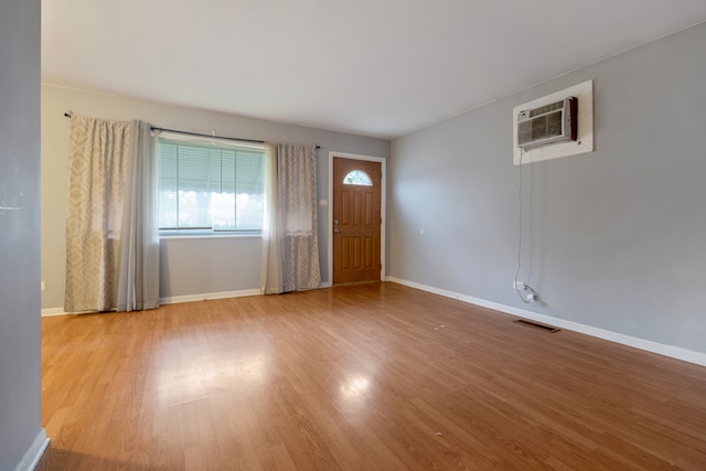 interior space featuring light hardwood / wood-style flooring and a wall mounted air conditioner