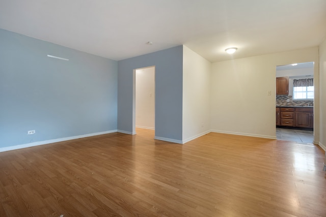 spare room featuring light wood-type flooring