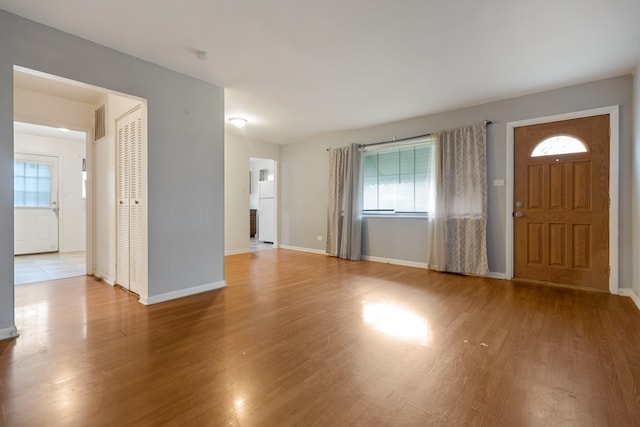 entryway with hardwood / wood-style flooring and a healthy amount of sunlight