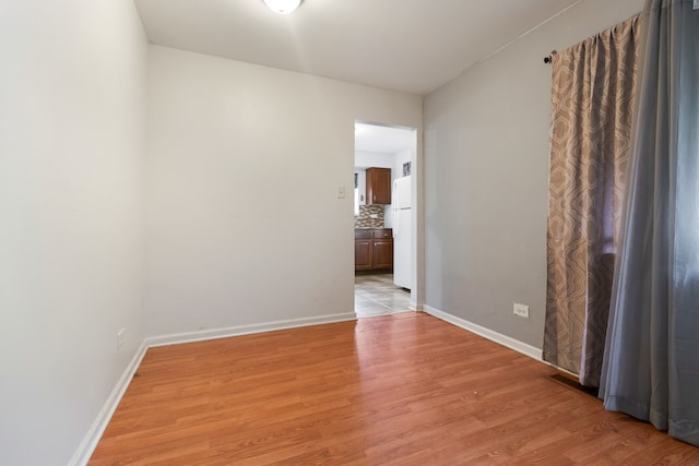 empty room with light hardwood / wood-style flooring