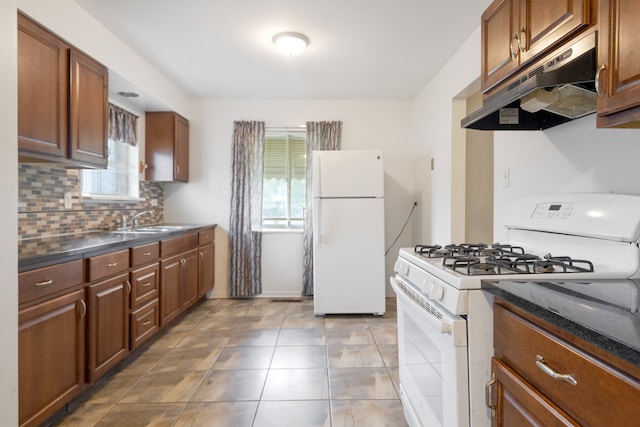 kitchen with light tile patterned floors, plenty of natural light, sink, and white appliances