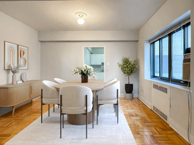 dining room featuring parquet flooring and radiator