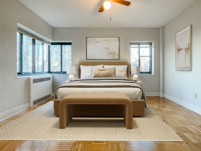 bedroom featuring light parquet flooring, radiator, and ceiling fan