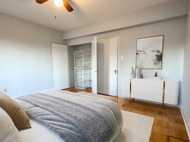 bedroom with ceiling fan and parquet floors