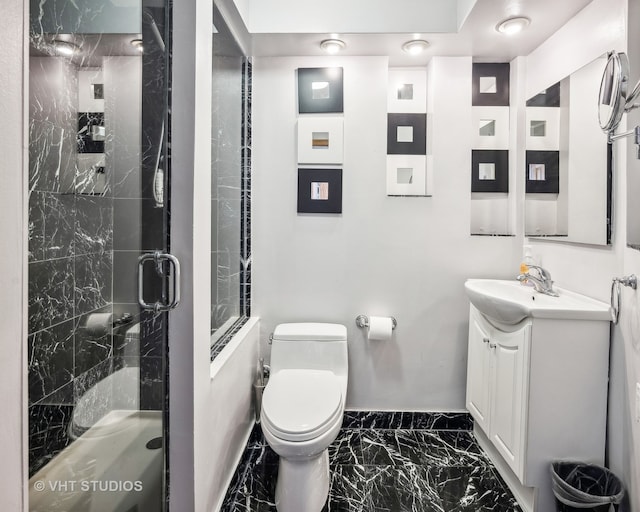 bathroom featuring vanity, toilet, and a shower with door