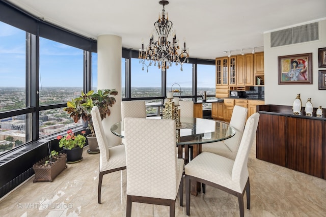 dining space featuring an inviting chandelier and expansive windows