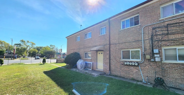 view of side of home with a lawn