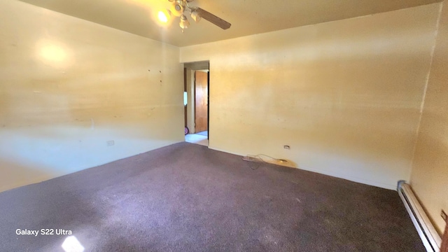 spare room featuring a baseboard heating unit, ceiling fan, and carpet floors