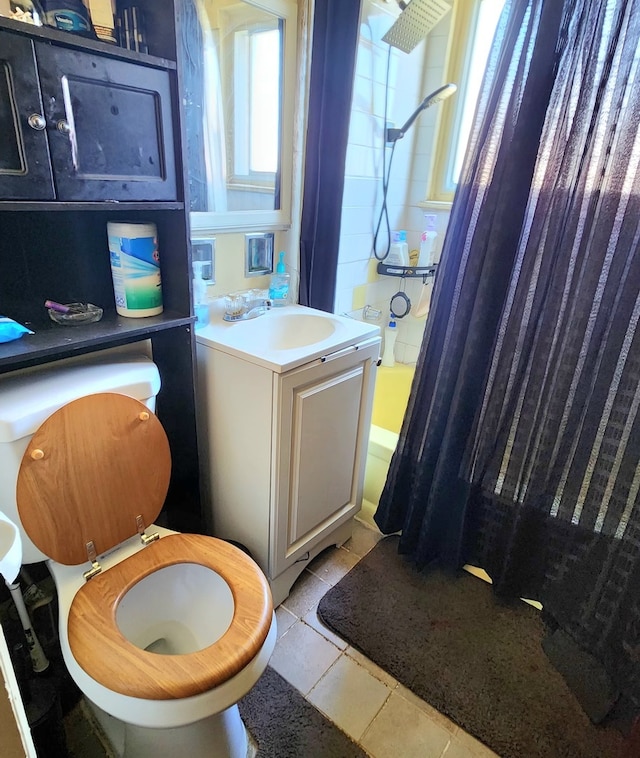 full bathroom with shower / bath combo with shower curtain, toilet, vanity, and tile patterned flooring