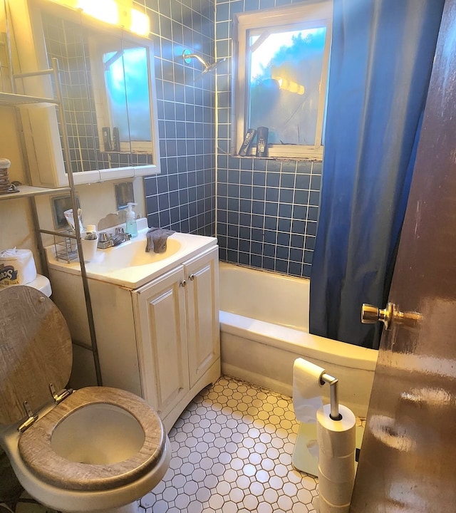 full bathroom with vanity, tile patterned floors, toilet, and shower / bathtub combination with curtain