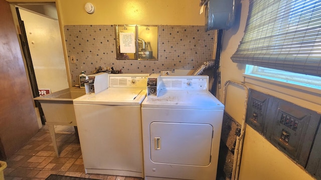 laundry room with tile walls and washer and clothes dryer