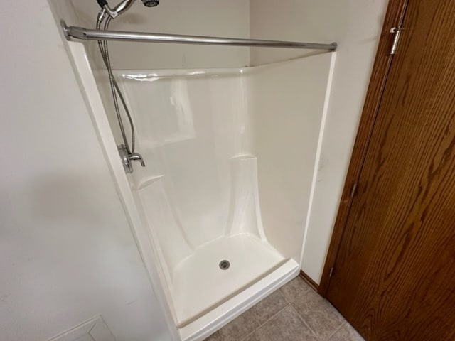 bathroom featuring tile patterned flooring and a shower