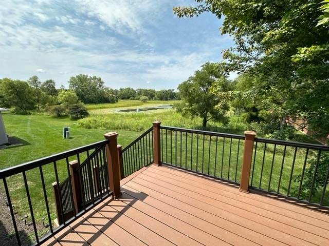 wooden terrace with a lawn