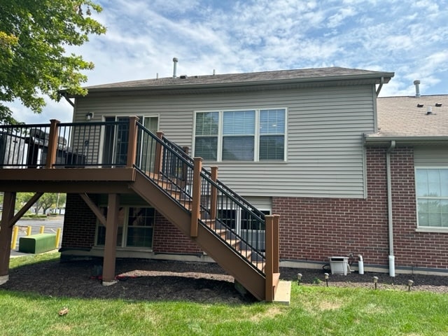 rear view of house with a wooden deck