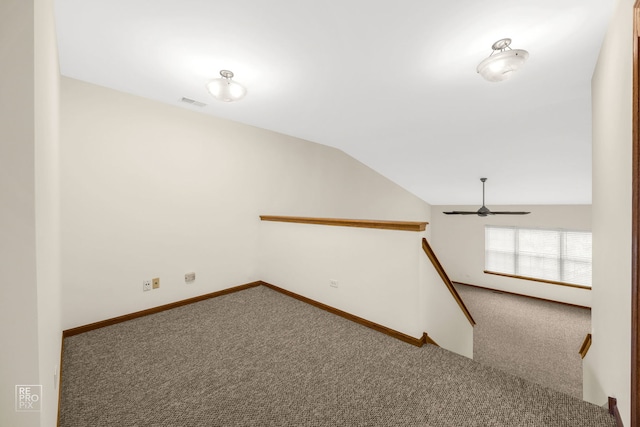 stairs with carpet floors, vaulted ceiling, and ceiling fan