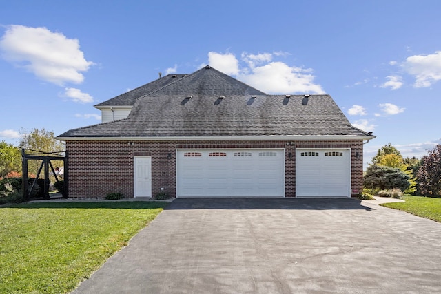 view of side of home with a garage and a yard