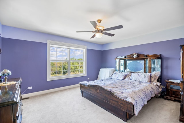 bedroom with ceiling fan and light carpet