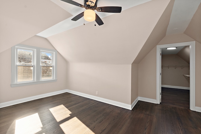 additional living space with ceiling fan, lofted ceiling, and dark hardwood / wood-style flooring