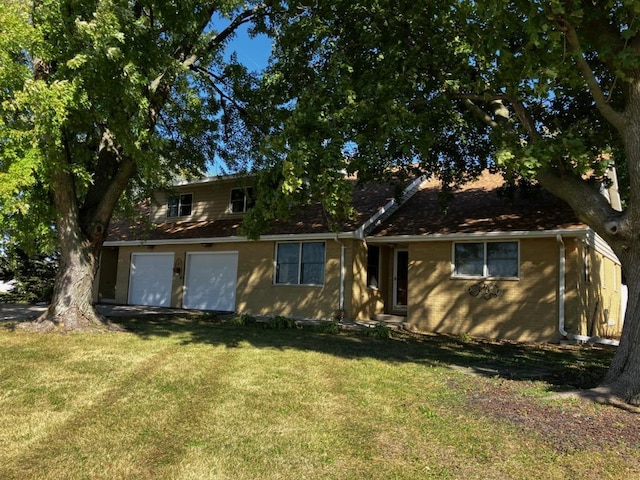 view of front of property featuring a front yard and a garage