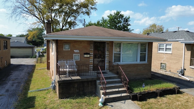 bungalow-style home featuring a front lawn