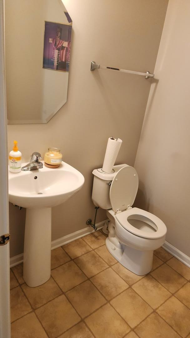 bathroom featuring tile patterned flooring and toilet