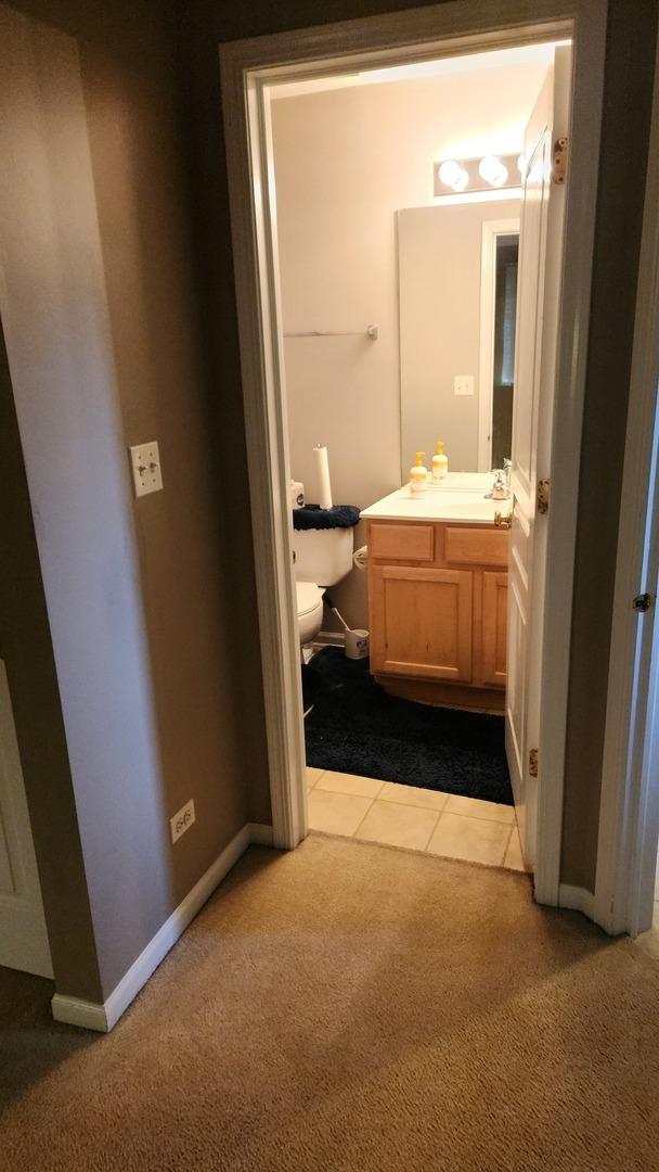 bathroom featuring tile patterned floors, vanity, and toilet