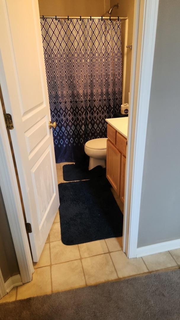 bathroom featuring tile patterned flooring, vanity, a shower with shower curtain, and toilet