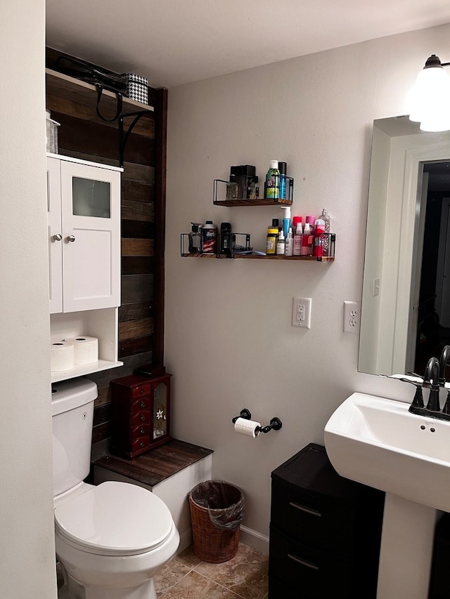 bathroom featuring sink, tile patterned floors, and toilet