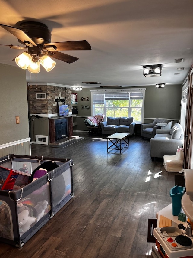 living room with ceiling fan and dark hardwood / wood-style floors