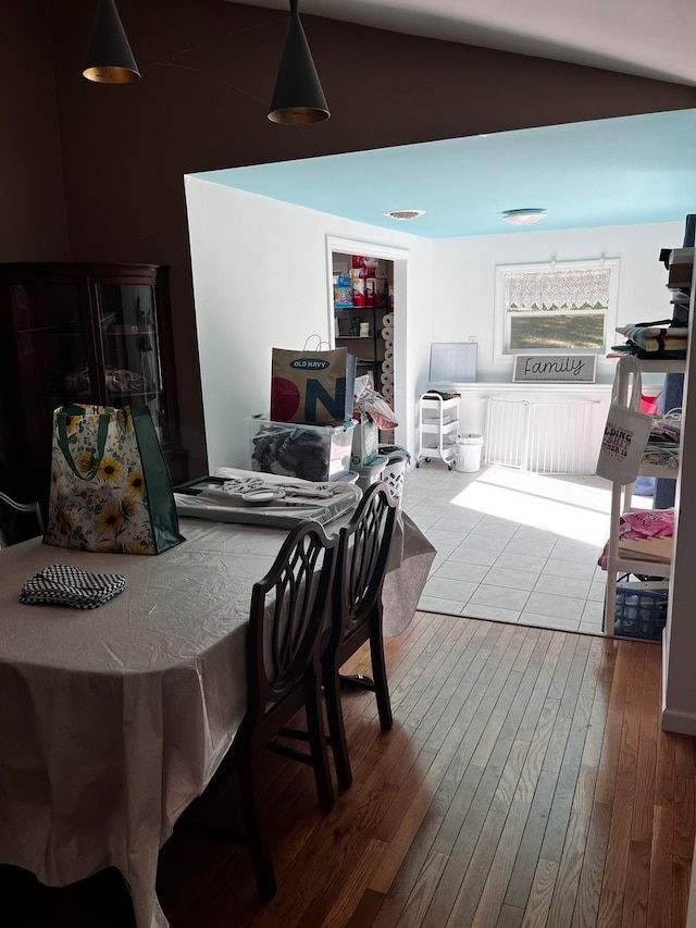 dining room featuring vaulted ceiling and hardwood / wood-style flooring