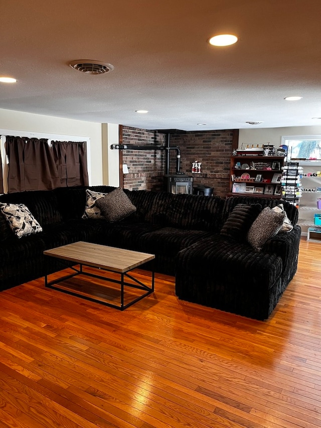 living room featuring a textured ceiling and hardwood / wood-style floors