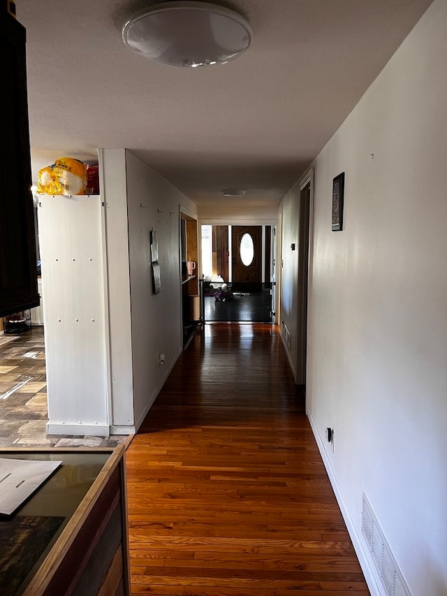 corridor with dark hardwood / wood-style floors