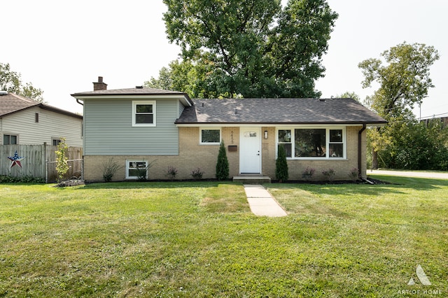 tri-level home with a front lawn