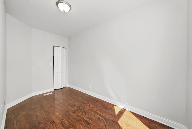 spare room featuring dark hardwood / wood-style floors