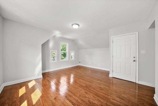 additional living space featuring hardwood / wood-style floors and lofted ceiling