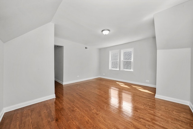 bonus room with lofted ceiling and hardwood / wood-style flooring