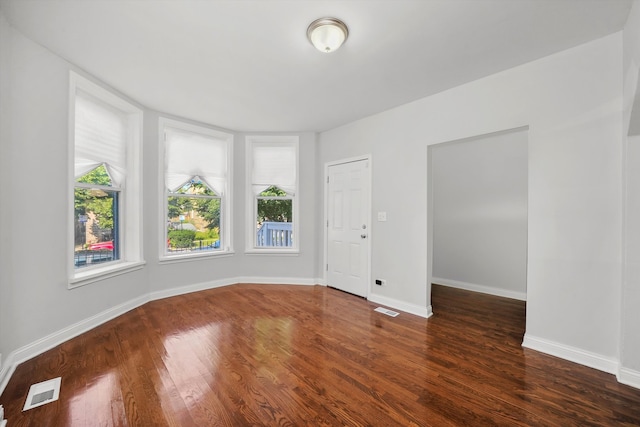 unfurnished room featuring dark hardwood / wood-style flooring