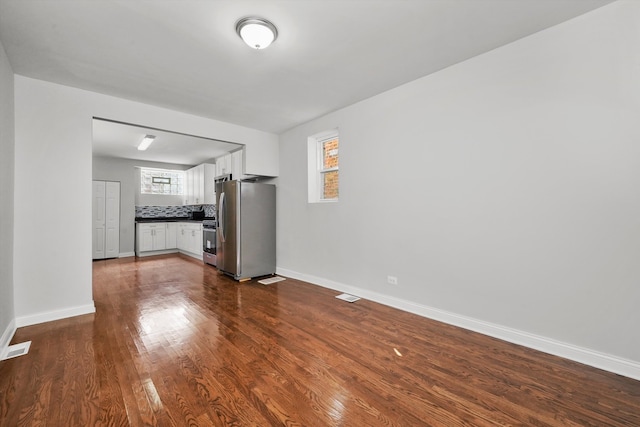 unfurnished living room featuring dark wood-type flooring