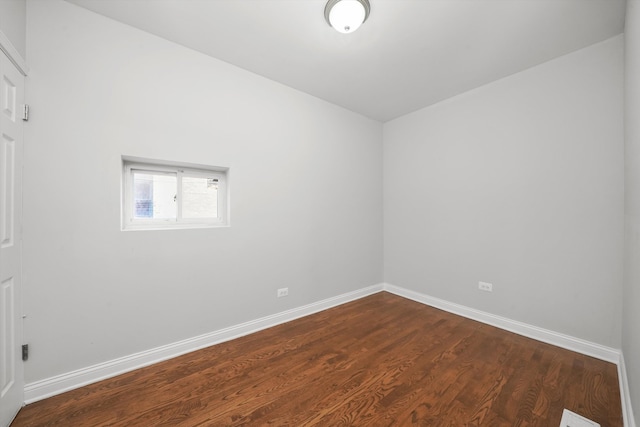 spare room featuring dark wood-type flooring