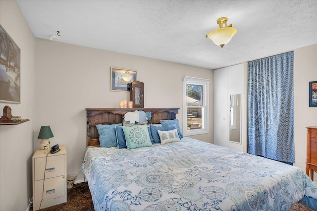 carpeted bedroom with a textured ceiling