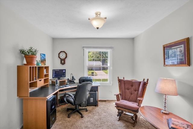 home office with a textured ceiling and carpet flooring