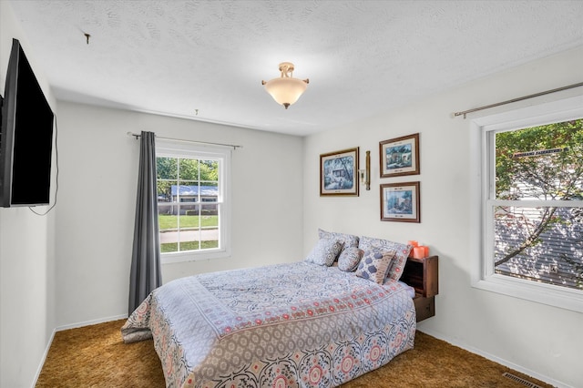 carpeted bedroom featuring a textured ceiling